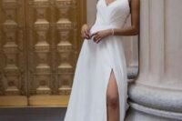 48 a fitting spaghetti strap wedding dress with a draped bodice, a pleated skirt with a slit and a train plus embellished shoes
