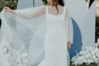 49 a gorgeous plain sheath wedding dress with thick straps, a square neckline and a long train and a pearl capelet for a modern lux look