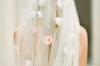 49 a veil with pearls and faux florals on the veil and its top looks very spring-like