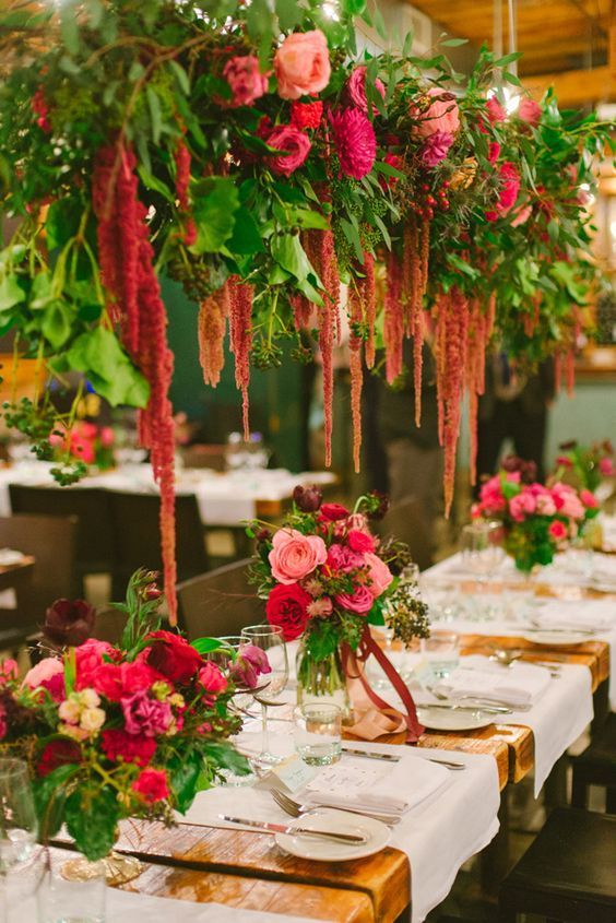 lush overhead floral arrangements of pink dahlias and peonies, roses and amaranthus plsu greenery are jaw-dropping