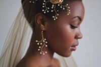 52 a bride wearing a gold veil and matching accessories with pearls and gold for a very sophisticated look