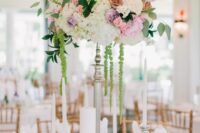 52 a delicate tall wedding centerpiece of white hydrangeas, pink peonies, rusr roses, greenery and green amaranthus