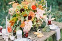 53 a chic and cool rustic fall wedding tablescape with lush and bright florals, greenery, deep purple and orange blooms, grey candles, printed plates and homemade jam as favors