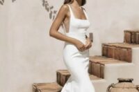53 a minimalist plain mermaid wedding dress with a square neckline, sheer inserts on the sides, a train for an edgy bridal look