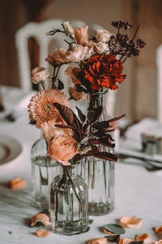 a cluster fall wedding centerpiece of blush and burgundy blooms and some dark foliage can be easily DIYed