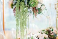 56 a tall wedding centerpiece of blush and white roses, green hydrangeas, greenery and green amaranthus is super chic