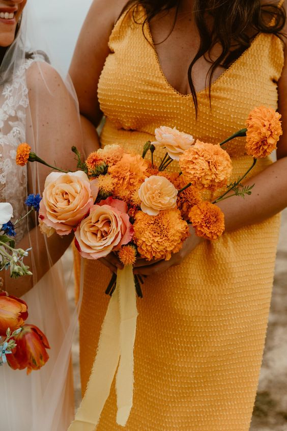 a lovely orange wedding bouquet of roses and marigolds is a great idea for a summer or fall colorful wedding
