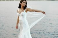 57 a modern glam mermaid wedding dress with a corset and a train plus a veil are a lovely combo for a modern glam bride