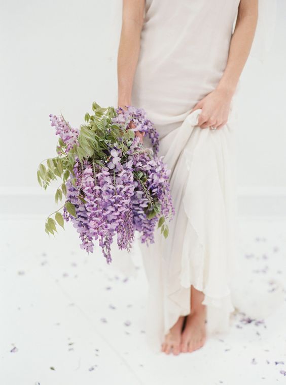 a spring wedding bouquet of wisteria and greenery is a cool idea for a relaxed and romantic summer wedding