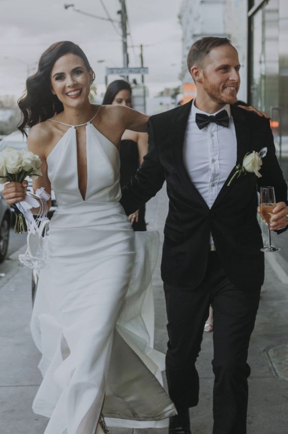 a modern halter neckline wedding dress with a cutout and slits ont he skirt is a modern or minimalist wedding idea