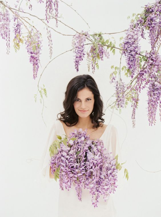 a cascading wedding bouquet of wisteria and greenery is a lovely idea for a spring wedding