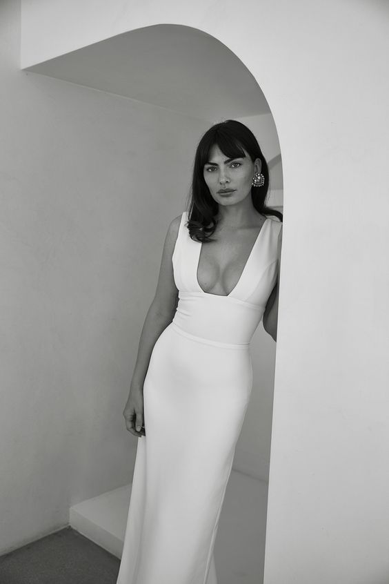 a modern plain fitting wedding dress with a deep and sexy neckline and thick straps is a lovely idea for a modern wedding
