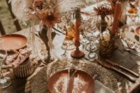 61 a fall boho wedding centerpiece of metal vases, pampas grass, neutral and bold blooms, candles is a beautiful solution to rock