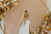62 a modern plain mermaid wedding dress with a square neckline, spaghetti straps and cutout sides plus a train for a chic and modern bridal look