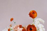 63 a gorgeous fine art wedding centerpiece of white, blush and orange blooms including mums and ranunculus is a refined wedding idea