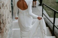64 a modern plain wedding dress with accented shoulders, a cutout back and a row of buttons plus a train is a gorgeous and chic idea