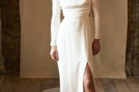 65 a modern plain wedding dress with long sleeves, a high neckline and a front slit, a train and black boots for a bold statement