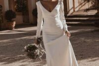 67 a romantic modern mermaid wedding dress with a deep neckline, long sleeves and a train is a lovely idea for a modern and romantic wedding