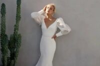 68 a sexy minimalist sheath wedding dress with a deep neckline, sheer puff sleeves and a train for a modern bride