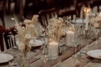 85 ethereal and airy boho fall wedding centerpieces of vases with white dried blooms and leaves plus candles look very chic