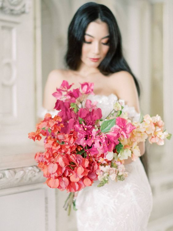 a beautiful hydrangea and bougainvillea wedding bouquet with some foliage for a colorful summer or destination wedding
