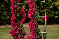 a beautiful magenta wedding arch with a bit of greenery is a bold and lovely decor idea for a modenr colorful wedding
