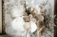 a beautiful wedding bouquet of neutral orchids, white poenies and lunaria plus some grasses and long ribbons is a lovely and lush wedding idea
