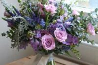 a beautiful wedding bouquet with purple, violet, pink blooms, astilbe, greenery and succulents is a lovely idea for a summer bride