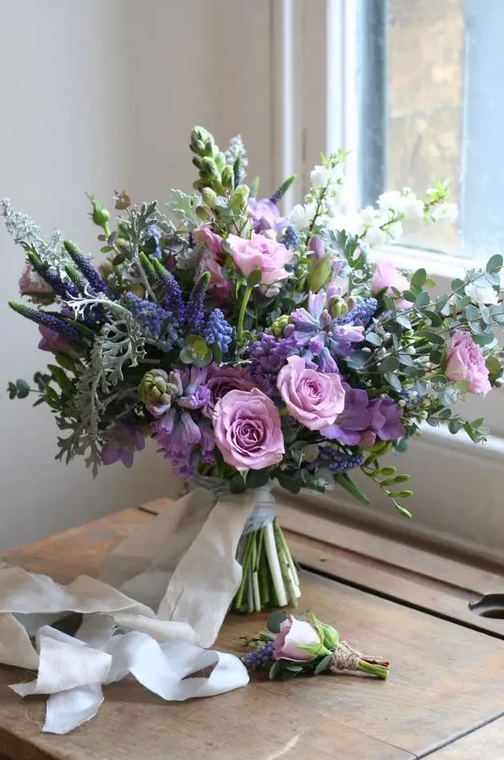 a beautiful wedding bouquet with purple, violet, pink blooms, astilbe, greenery and succulents is a lovely idea for a summer bride