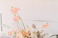 a blush wedding centerpiece of roses, hydrangeas, anthuriums is a chic and lovely idea for a garden wedding