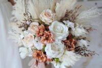 a boho wedding bouquet of roses in white, peachy and rust, pampas grass and lunaria is a cool idea for a boho bride