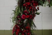 a bold and catchy wedding arch with greenery, succulents, red and burgundy roses and amaranthus for a stunning fall or Halloween wedding