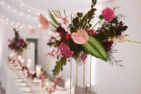 a lovely wedding table with tall centerpieces