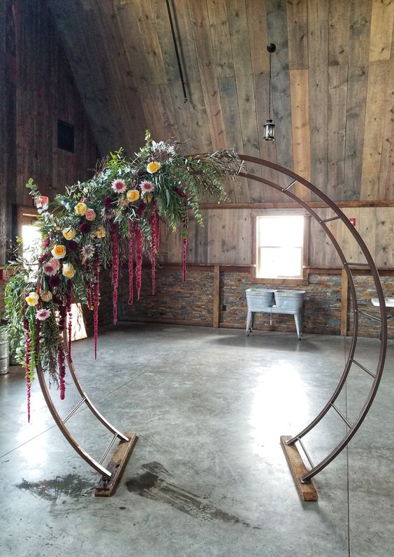 a bold fall wedding arch, a moon gate with greenery, yellow, blush, burgundy flowers and amaranthus is a lovely idea with a touch of color