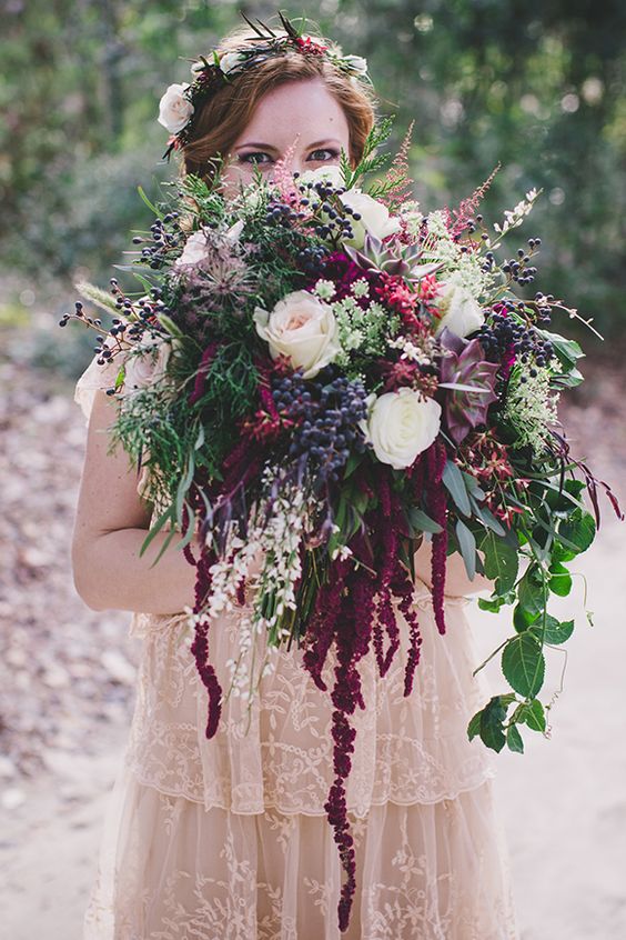 a bold forest wedding bouquet of white roses, succulents, berries, greenery and grasses plus amaranthus for a fall woodland wedding