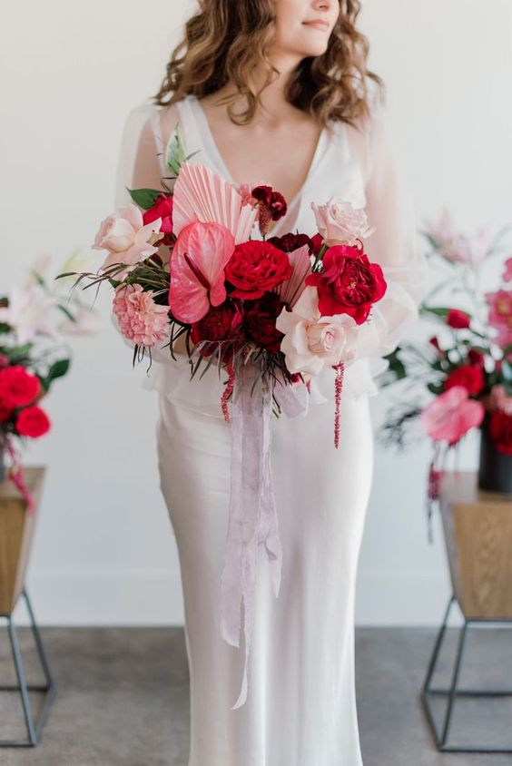 a bold pink wedding bouquet of anthurium, roses and carnations, pink fronds and ribbons is a cool idea for a colorful wedding