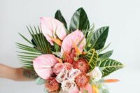 a bold tropical wedding bouquet of pink anthurium, pink and blush roses and pincushion proteas, some bold leaves and fronds