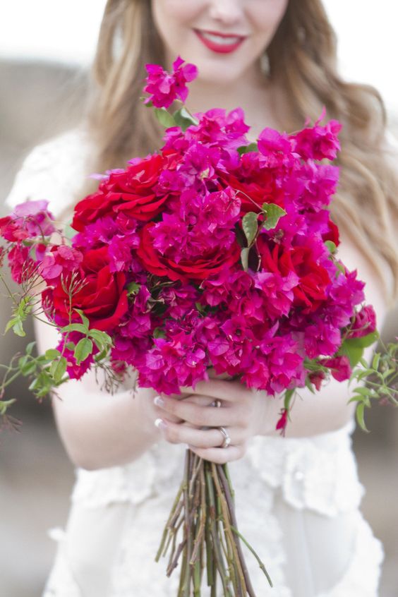 a bold wedding bouquet of bougainvilela and red roses plus some greenery is a stunning idea for a colorful wedding