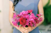 a bold wedding bouquet of bougainvillea and red roses will fit a Mediterranean wedding or a tropical one