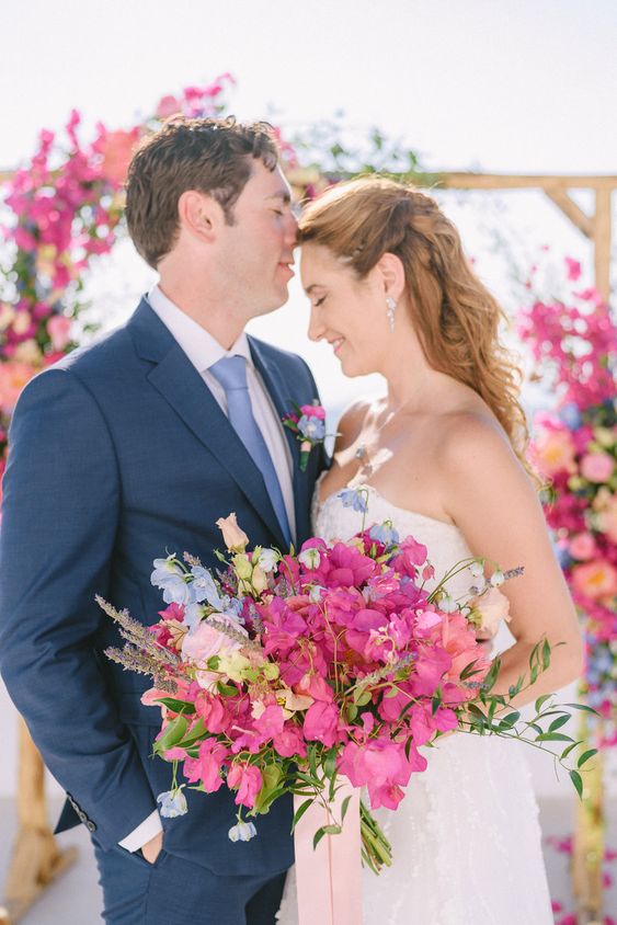 a bold wedding bouquet of bougainvillea, blush and blue flwoers and greenery is a stunning idea for a summer wedding