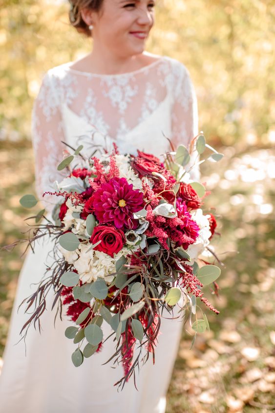 a bold wedding bouquet of red and burgundy roses and dahlias, white hydrangeas, amaranthus and eucalyptus is a bold and cool idea