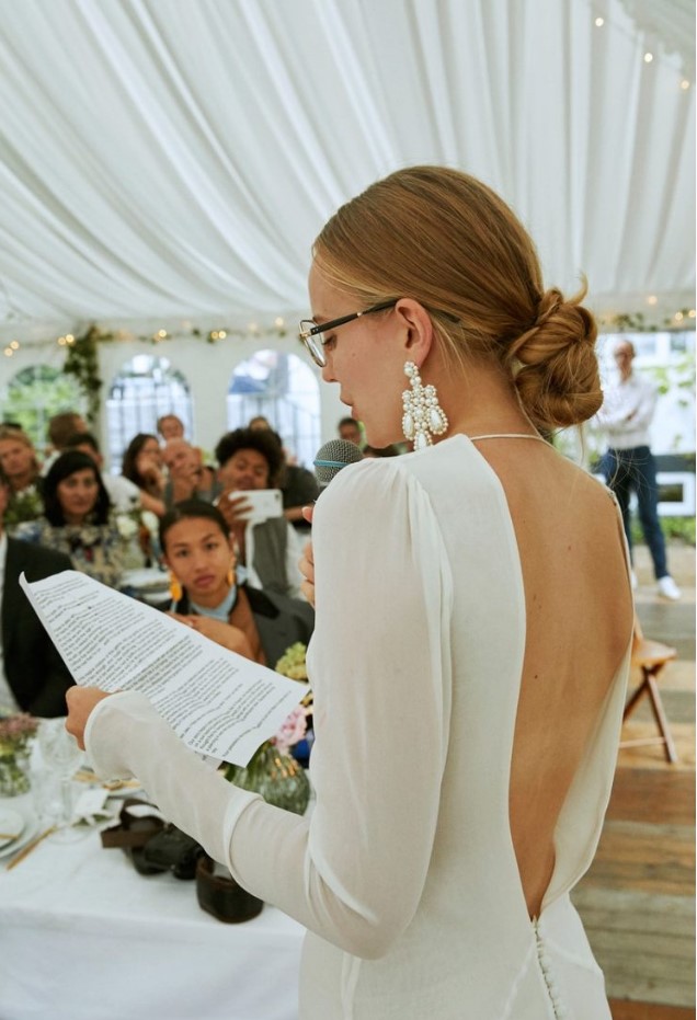 a bride rocking statement pearl earrings to highlight her minimalist wedding look