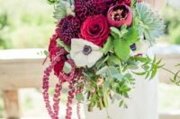 a bright wedding bouquet of burgundy mums, roses and peonies, a white anemone, greenery and amaranthus for the fall