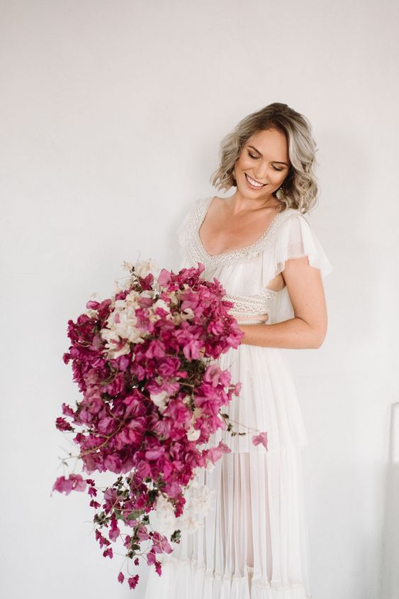 a cascading wedding bouquet of bougainvillea and white hydrangeas for a colorful destination wedding