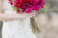 a catching bougainvillea and red rose wedding bouquet plus some greenery is a stunning idea for a summer wedding