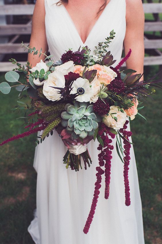 a catchy fall wedding bouquet of blush and white roses and anemones, thistles, succulents, greenery and amaranthus is wow