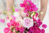 a catchy wedding bouquet of bougainbillea, light pink roses and greenery is a chic and bold idea for a summer wedding