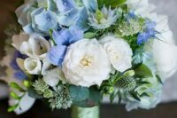 a catchy wedding bouquet of white blooms, blue hydrangeas, greenery and thistles is a stylish and chic idea with plenty of texture