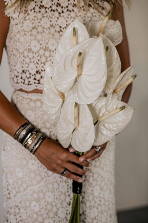 a catchy white anthurium wedding bouquet is a bold statement at a modern wedding, great for a boho bride, too