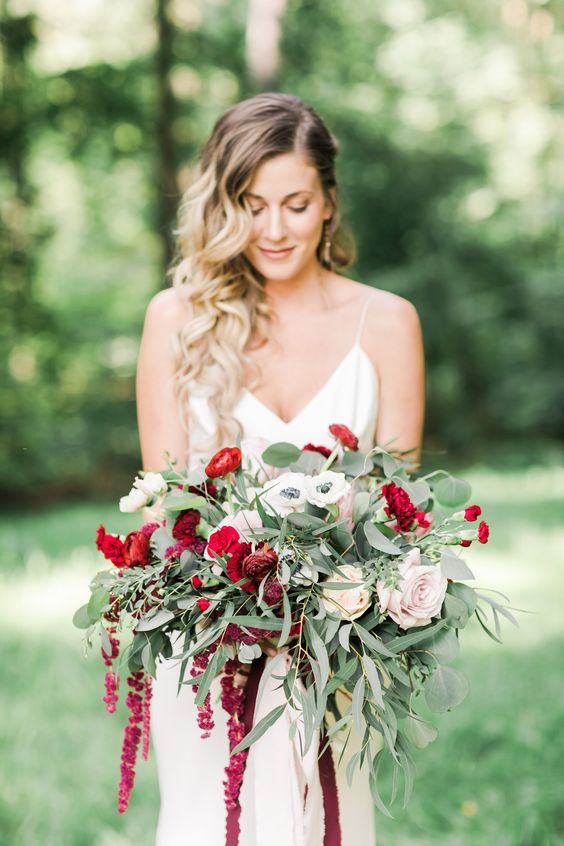 a chic and bright wedding bouquet of white anemones, blush roses, red ranunculus, amaranthus and greenery for a wedding with a touch of red